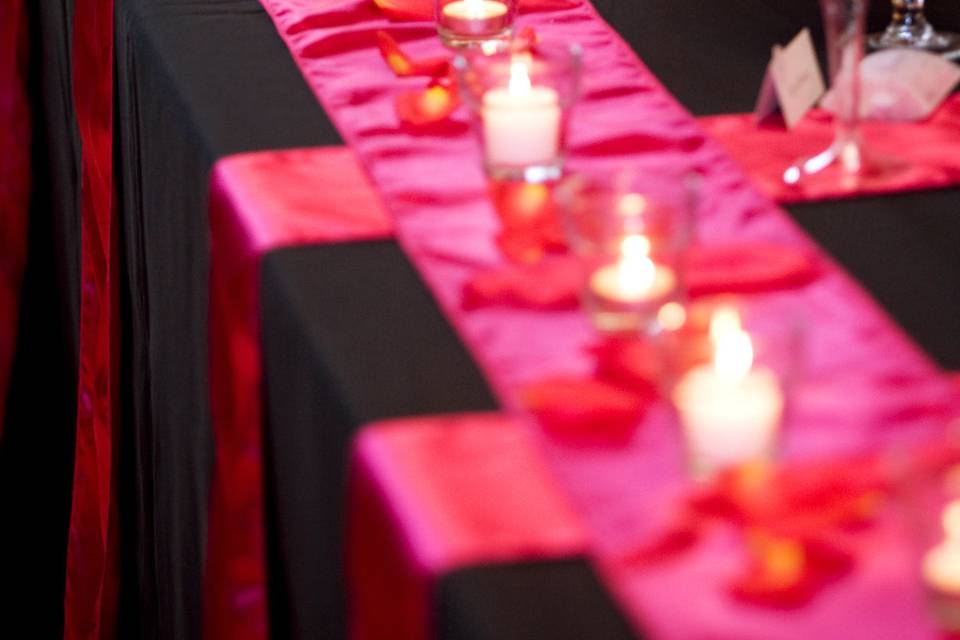 Black and pink table setup with candles