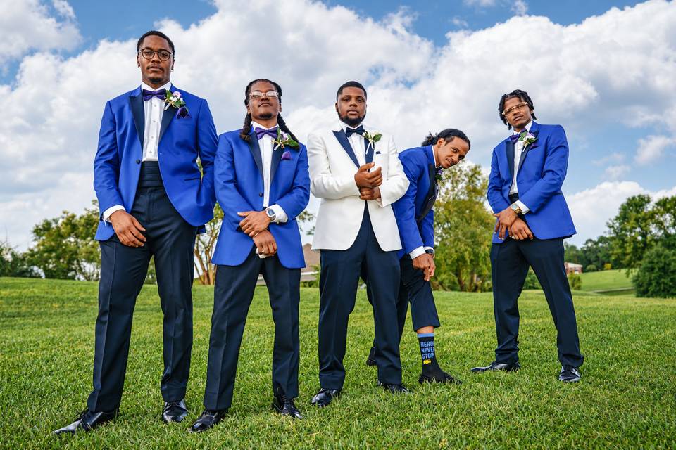 Groomsmen posing outdoors