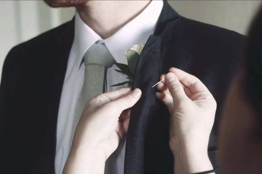 Putting on boutonniere