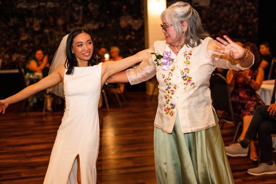 Bride and mother dancing