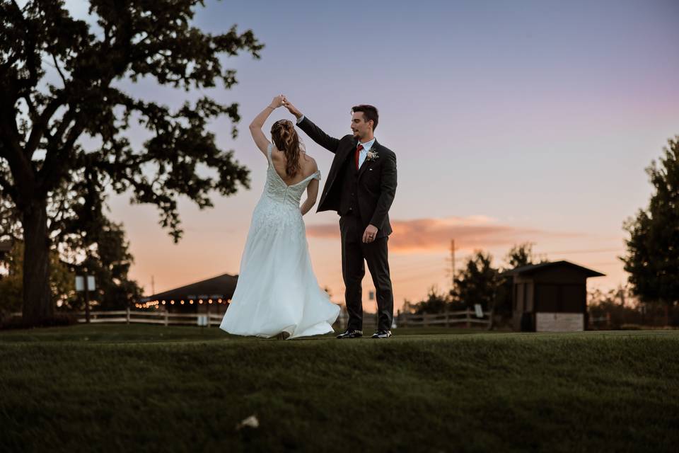 Groom twirling bride