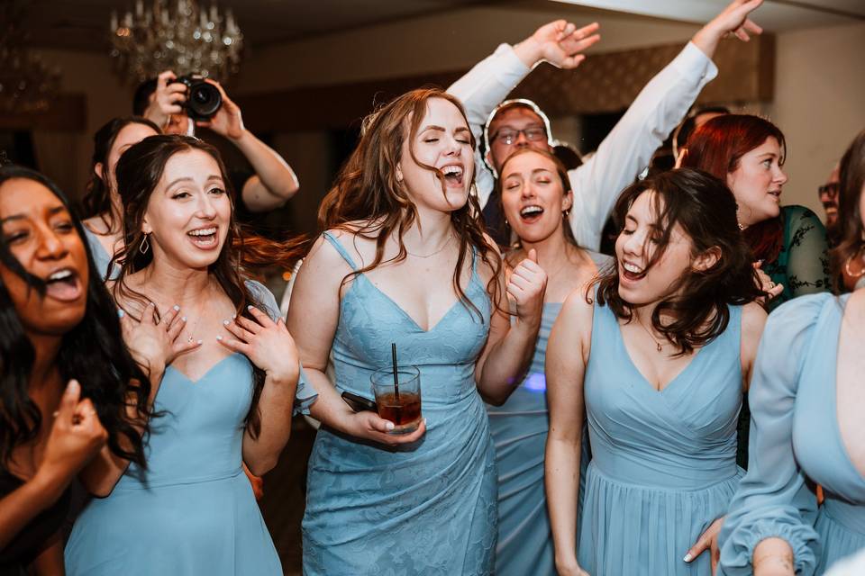Bridesmaids singing and dancin