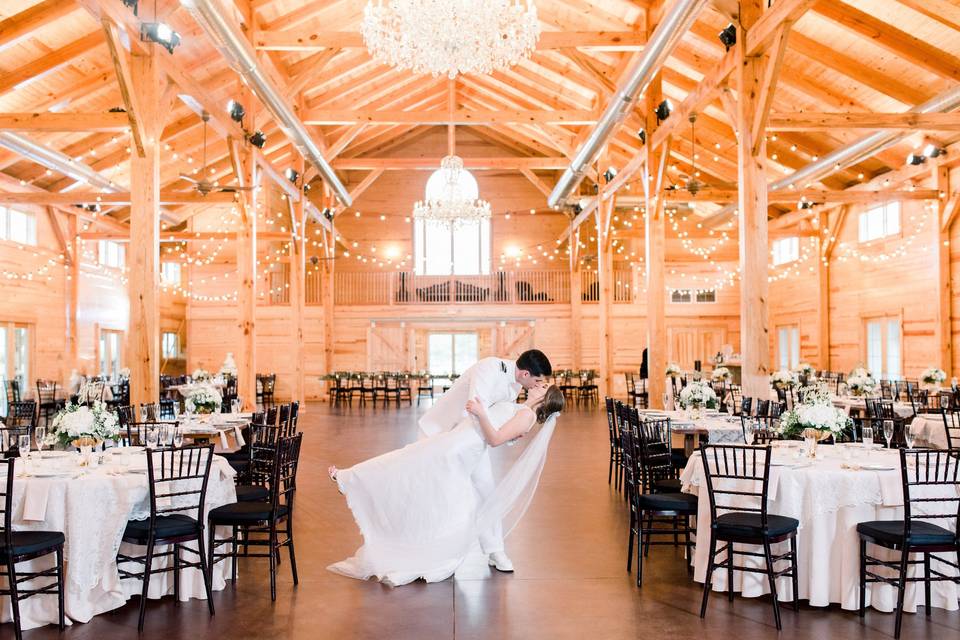 Newlyweds kissing in the barn