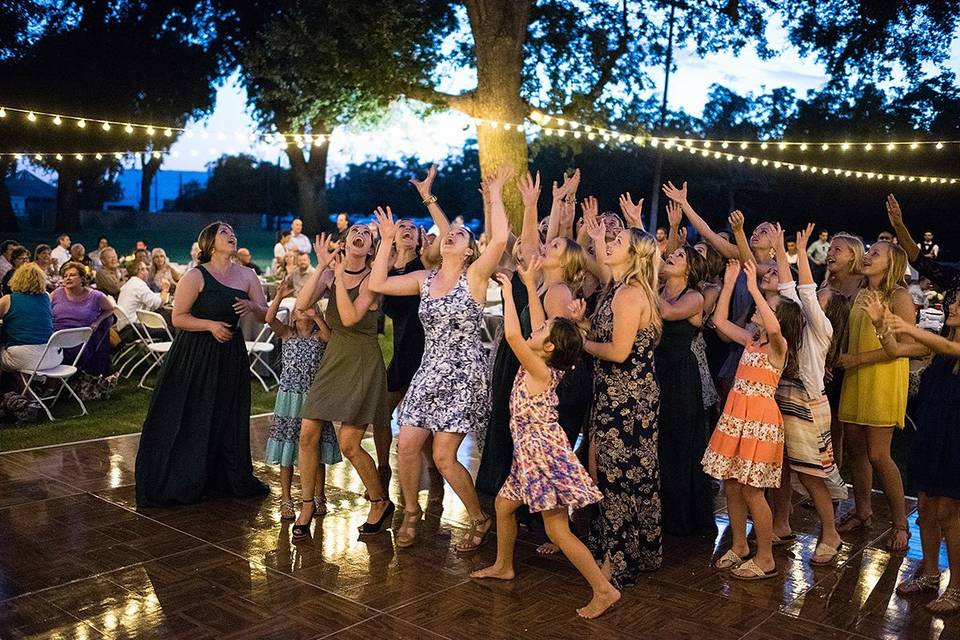 Fierce competition for that bouquet!Photo by - Third Element Photo + CinemaWedding Coordinator - The Social SpreeRentals - Expo Party RentalsLighting - Light Up The WallsDJ/Emcee - AMS Entertainment