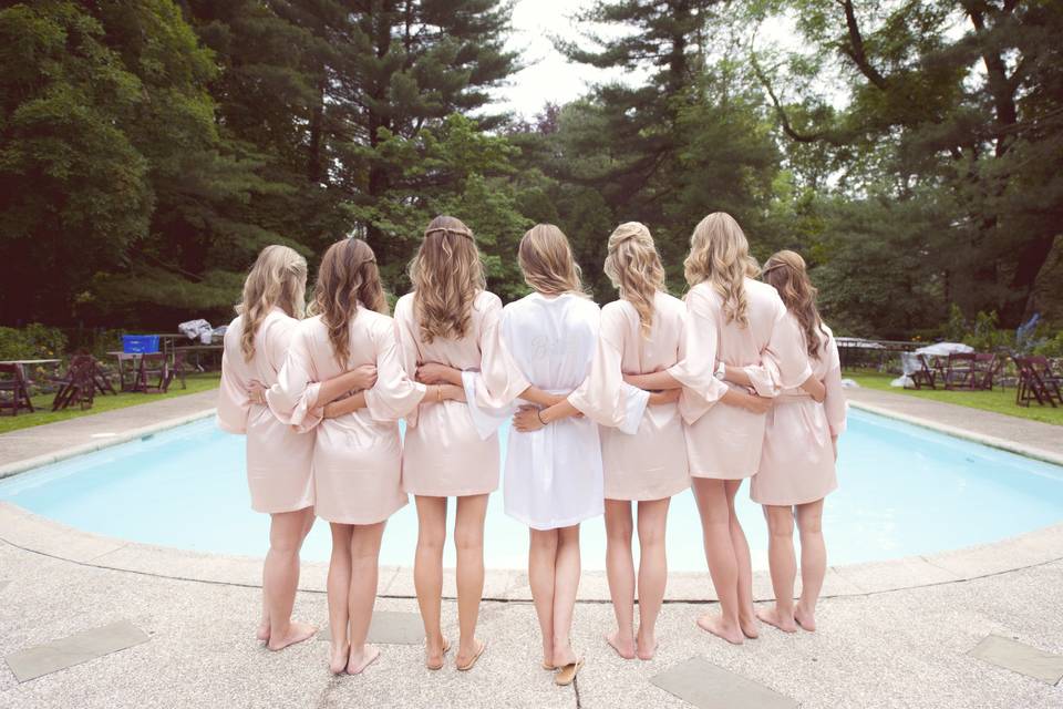 Bride with bridesmaids by the pool