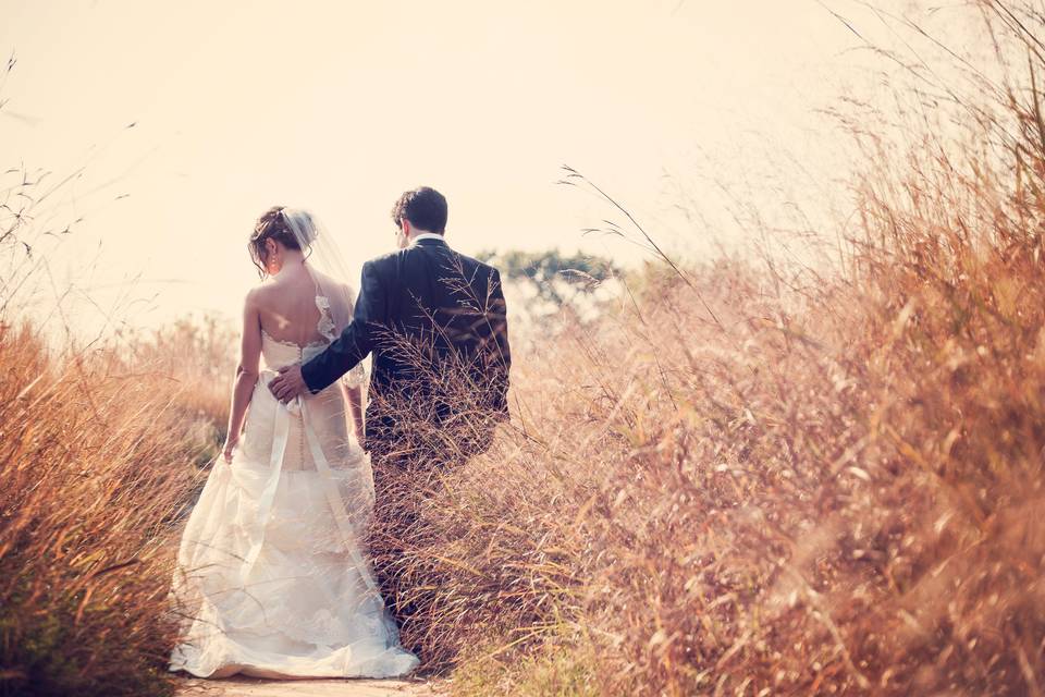 Bride and groom posing in field