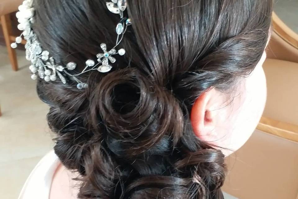 Side swept hair curls with silver hair ornament