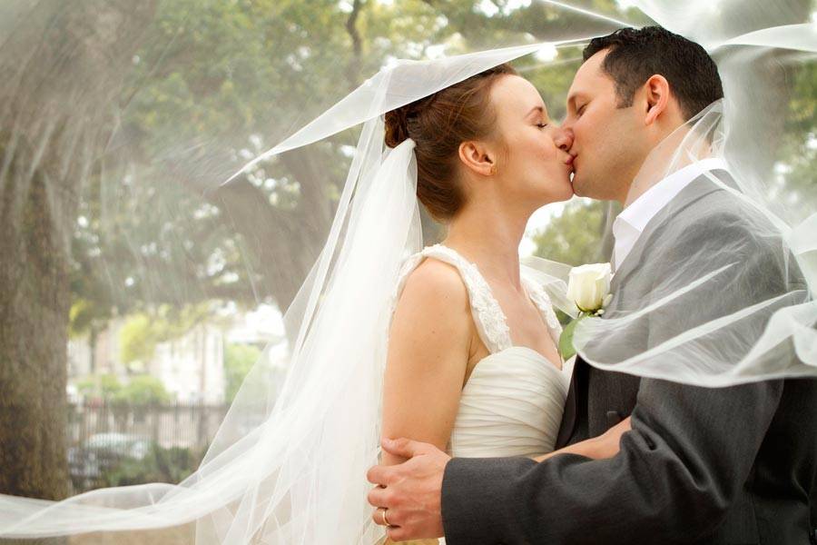 Bride and Groom share a kiss under her veil in New Orleans, Louisiana