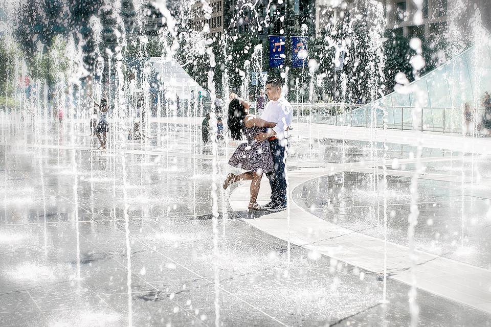 Engaged couple dancing in fountains in Philadelphia PA. We do weddings nation-wide!