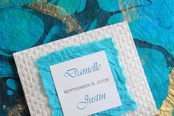 Hand crafted bamboo woven envelope with handmade paper and inside is a the place card that is custom made for each guest.