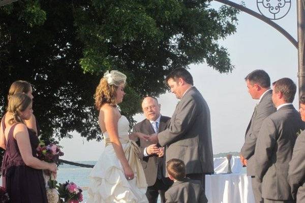 Groom putting the ring on his bride