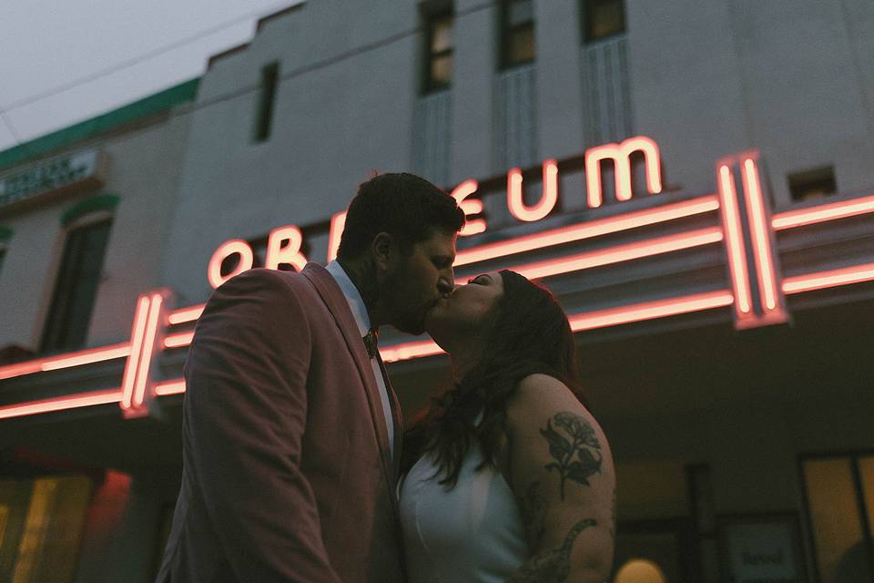 Couple kissing under neon