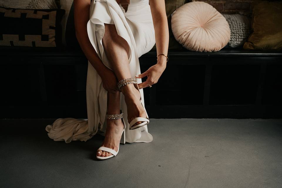 Bride putting on her shoes