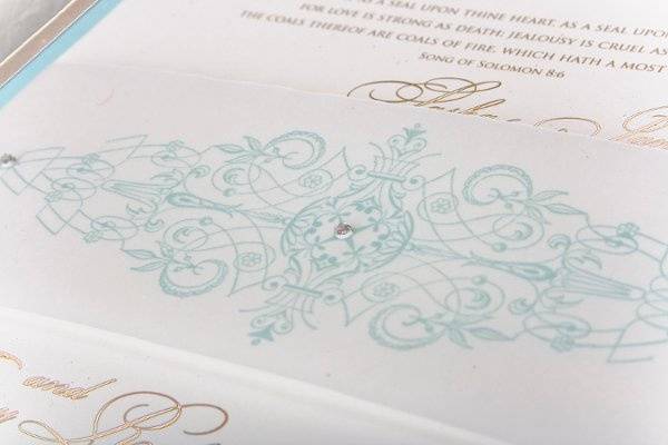 Three Swarovski crystals was precisely placed to highlight the scroll-like design printed on the vellum bellyband.