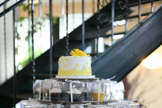 Simple Cake Topper above a Tower of Cupcake Favors