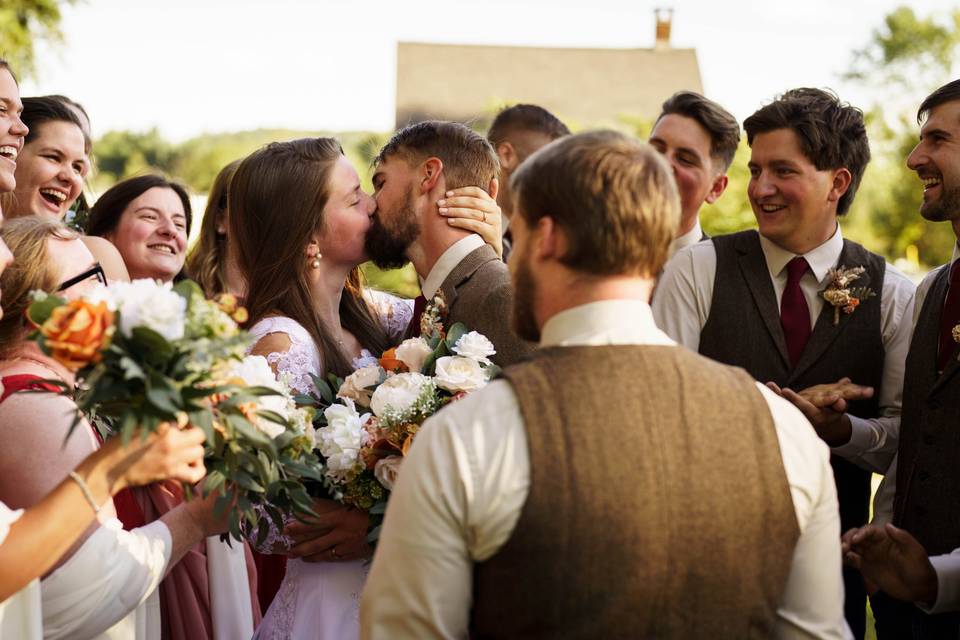 Bridal party cheers for couple