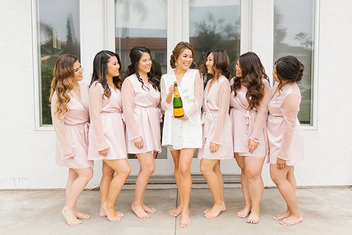 Bridesmaids pop champagne