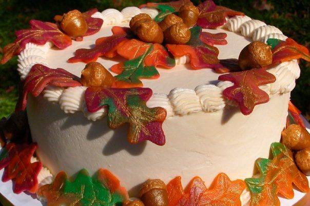 Handmade marzipan acorns and leaves adorn this lovely fall wedding cake.