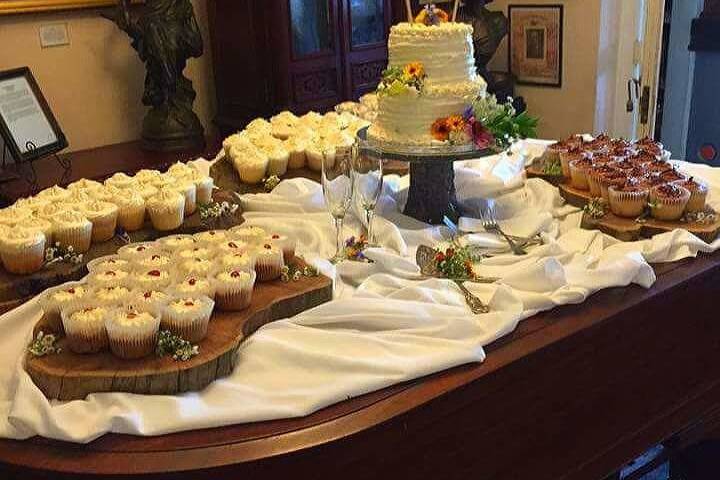 A piano was the perfect place for this mini wedding cake and 12 dozen cupcakes!