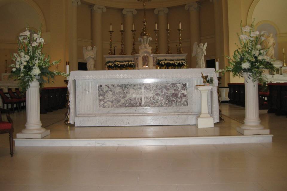 Formal all white ceremony with classic ceremony altar designs.