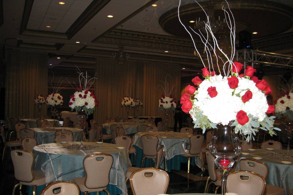 A holiday inspired reception with centerpieces of roses, hydrangea and white birch branches.