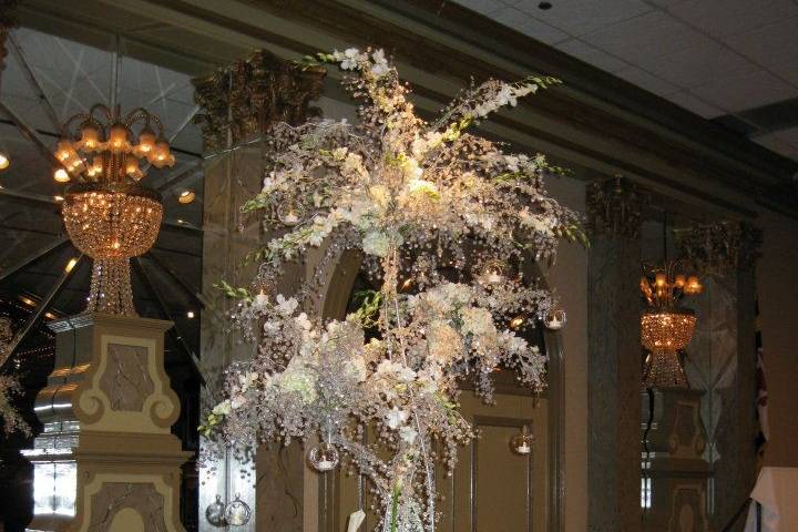 Exquisite reception centerpieces filled with bling! Cascades of lights and jewels among orchids and roses.