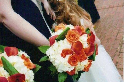 These orange and white bouquets were the perfect compliment to the navy blue bridesmaids' dresses.