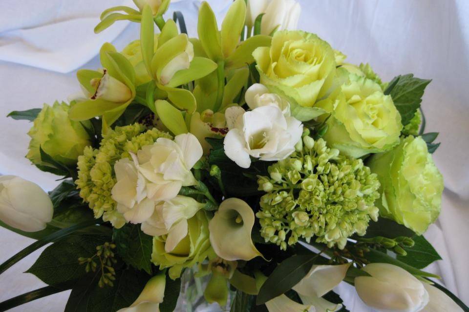 Green and white flowers are a popular choice, this bouquet features cymbidium orchids, roses, green hydrangea and tulips.