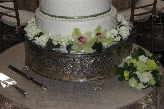 This beautiful cake is adorned with cymbidium orchids and roses.