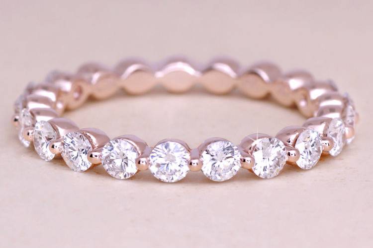 A custom rose gold thin diamond eternity wedding band, featuring fine white diamonds. Ascot Diamonds #ascotdiamonds