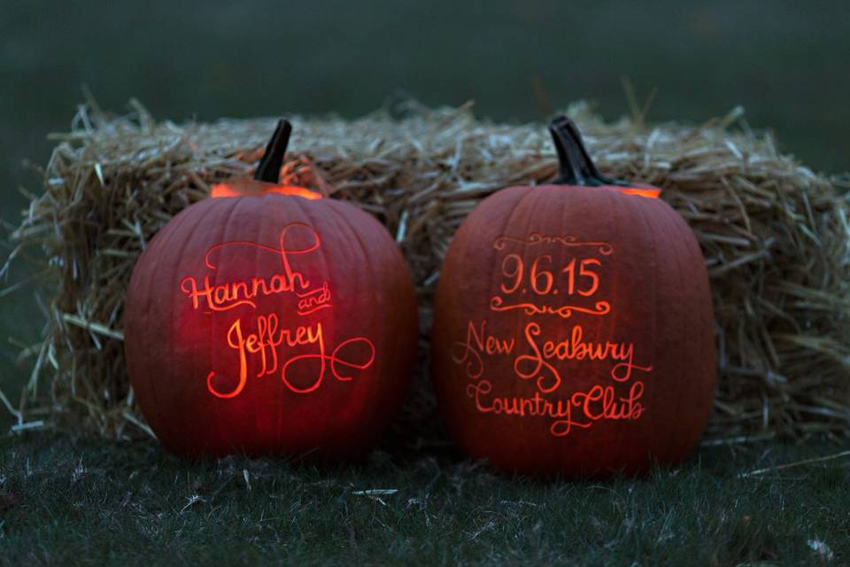 Lit pumpkins with the bride & groom's names, venue and date.