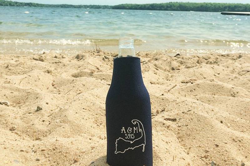 Custom designed bottle coozie with the Cape Cod arm, Couple’s initials and wedding date.