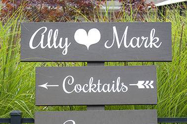 Hand painted directional signs in brown and white for a Cape Cod Wedding