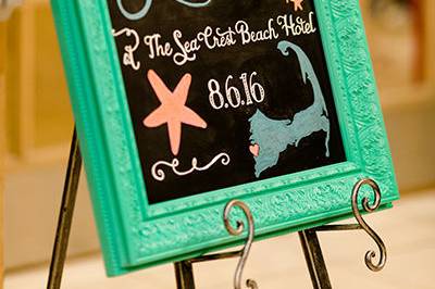 Custom Welcome Chalkboard in a painted aqua frame for a Cape Cod wedding at Sea Crest Beach Hoel in Falmouth, Massachusetts. Photo courtesy of Shoreshotz Weddings.
