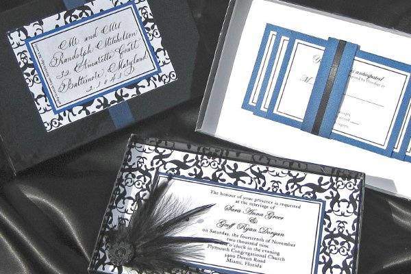 Custom boxed invitation using hand-made feather, bead, and wire embellishment.