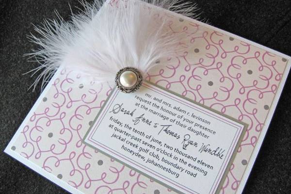 Lavender and gray wedding invitation with white feather and pearl button brooch.  Dogwood Blossom Stationery.