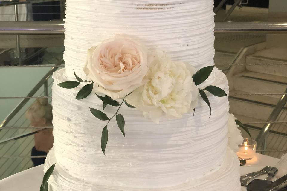 3-tiered cake with whipped cream frosting