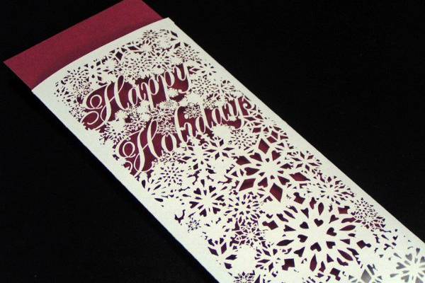 This is our Happy Holidays narrow invitation sleeve in Lustre Silver. More info and choices at papelcouture.com.
