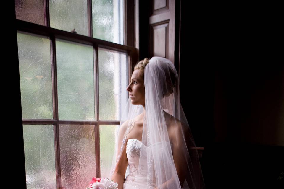 Bride gazing through the window