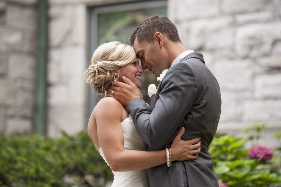 Newlyweds kissing outside