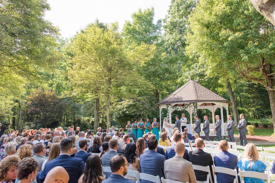 An outdoor gazebo ceremony