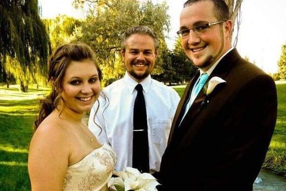 Officiant with happy couple