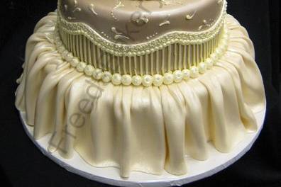 All white wedding cake with flowers on top