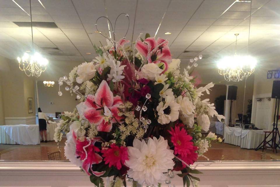 tall centerpiece with a variety of flowers with bling