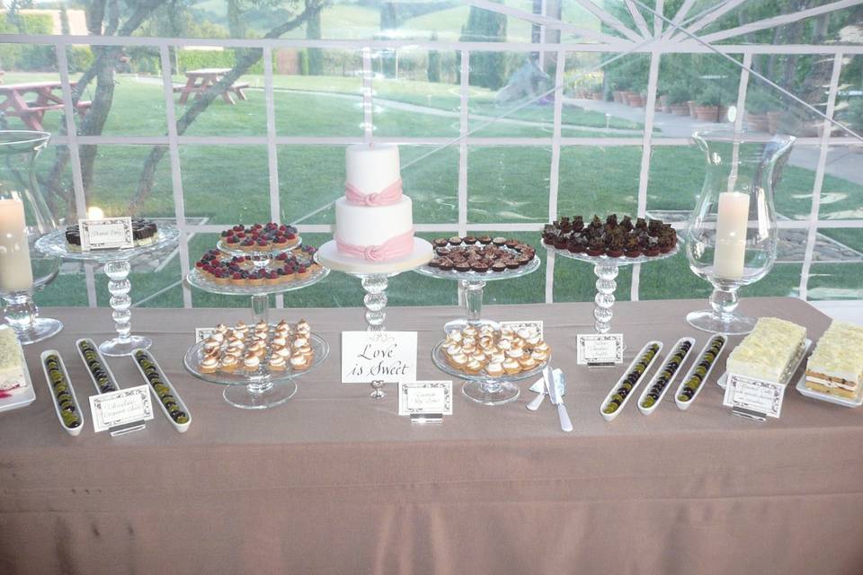 Dessert Table with a cutting cake and petit fours.