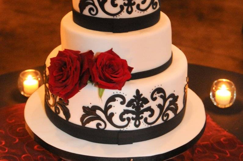 Wine country cake in a barrel room with navy appliqued scrolls