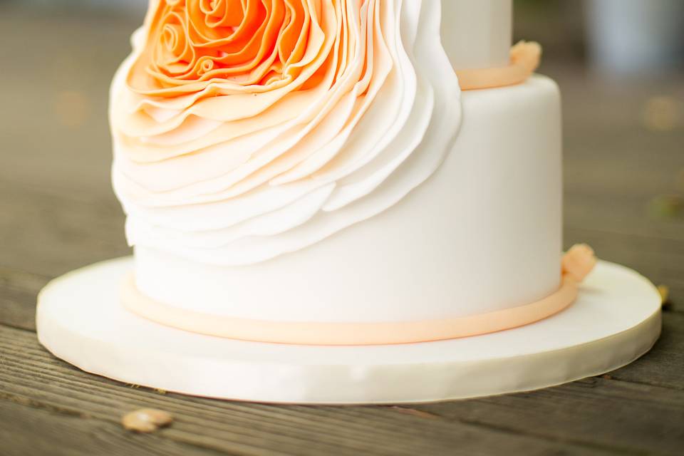 Wine country cake in a barrel room with navy appliqued scrolls