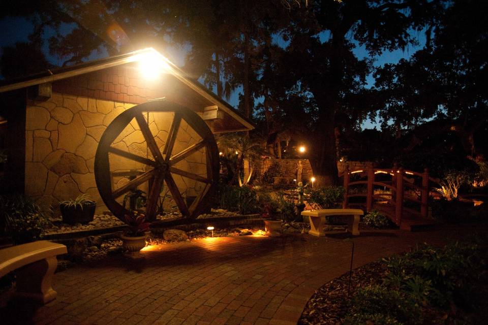 Water wheel and gardens at night