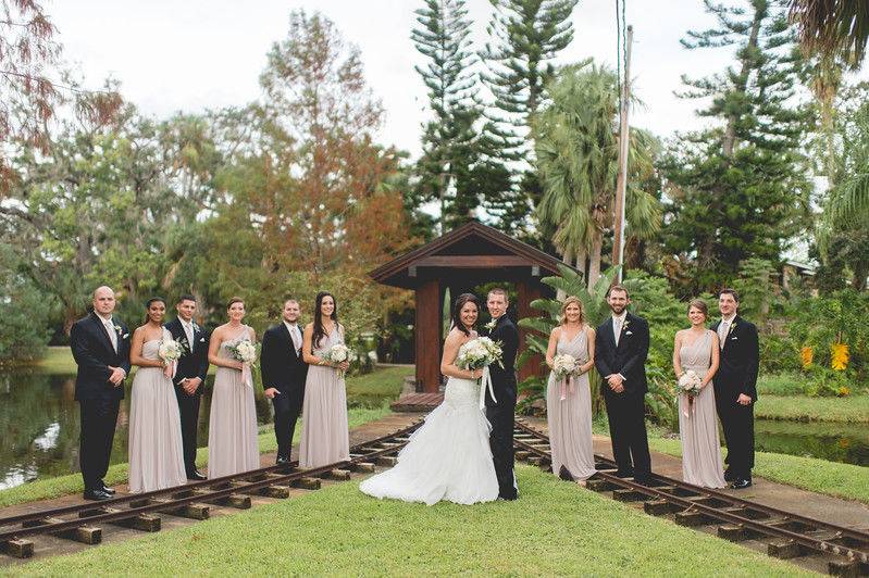 Bridal party on train tracks leading to bridge