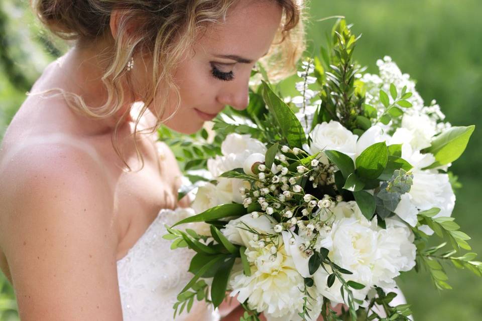 Bride smelling her bouquet